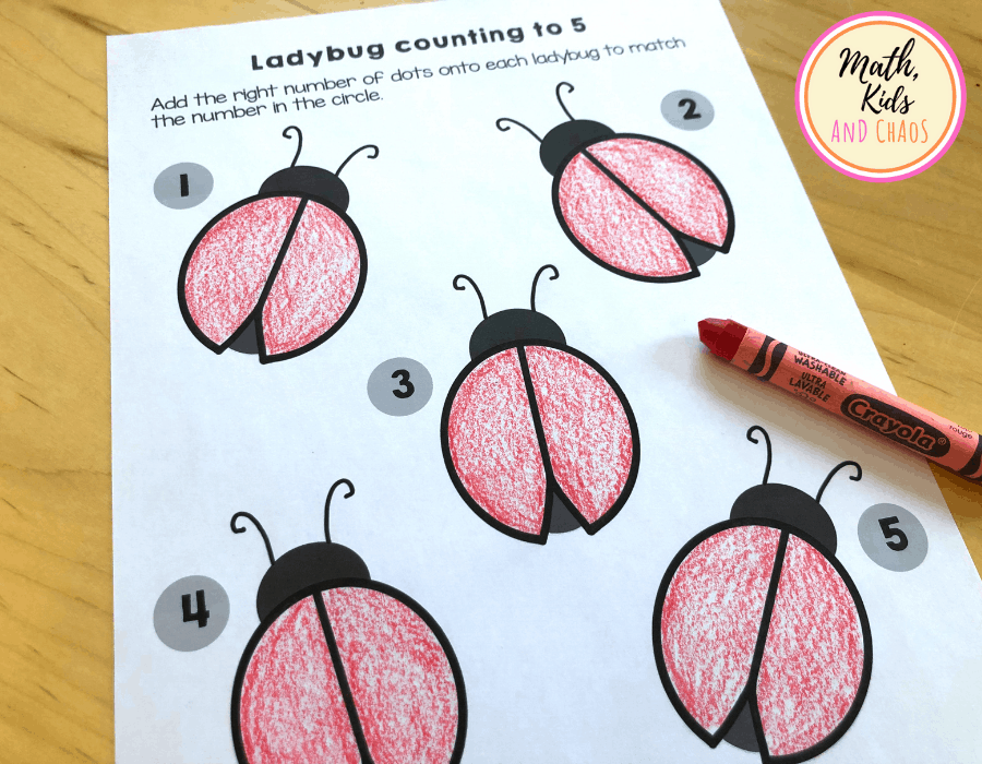 Ladybug printable on white paper with ladybugs coloured in red.