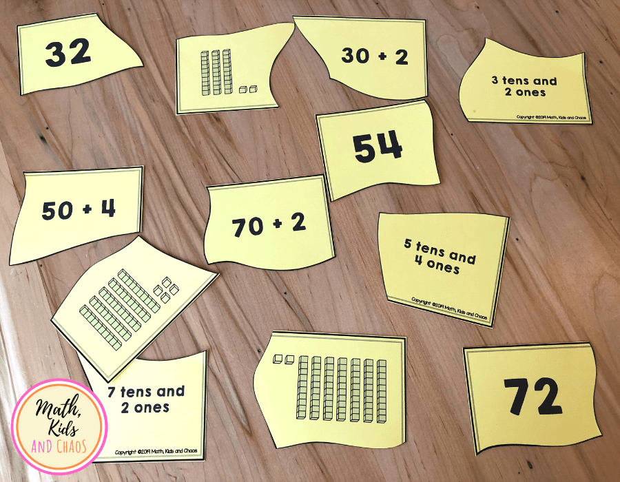 Puzzle pieces for 32, 54 and 72 jumbled up on table top.