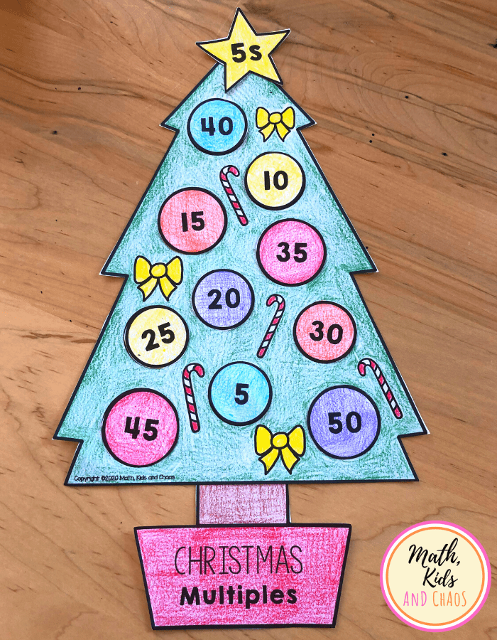 Completed Christmas tree math craft for multiples of 5 on table top.