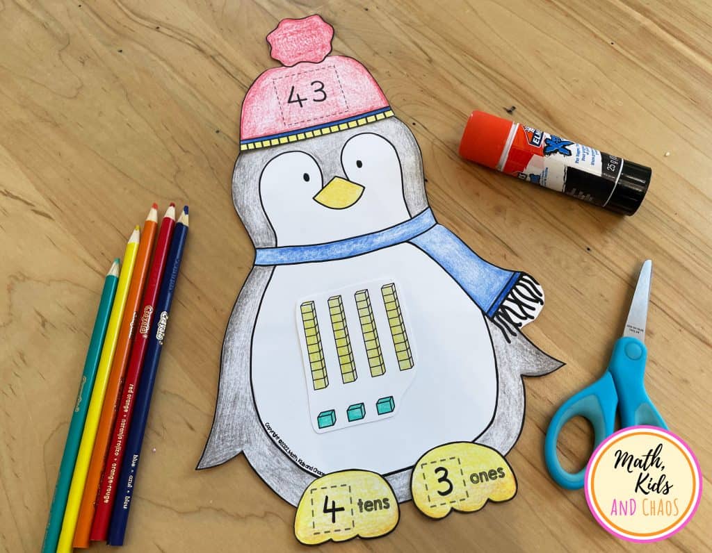 COMPLETE PENGUIN MATH CRAFT ON TABLE WITH SCISSORS, GLUE AND PENCILS